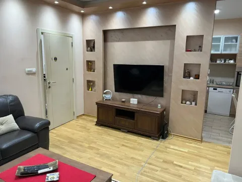 Living room with a TV unit and decorative wall niches. - image 12
