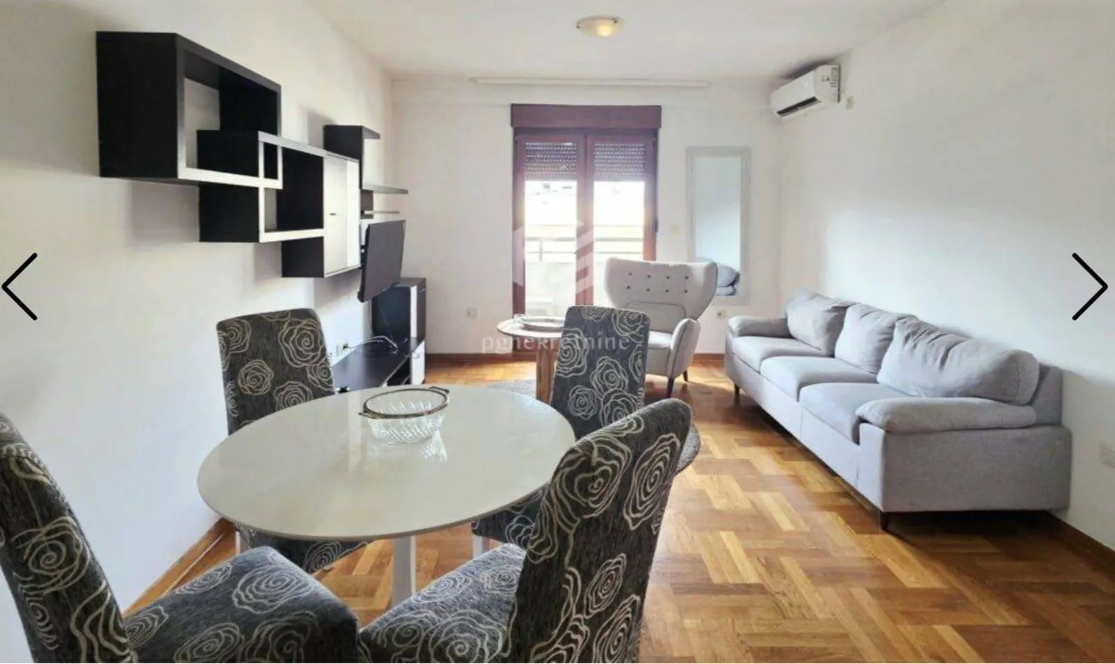Living room with a dining area and sofa.