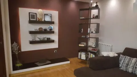 Living room featuring decorative shelving and a sofa. - image 2