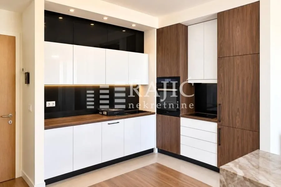 Modern kitchen with white and wood finish cabinets.