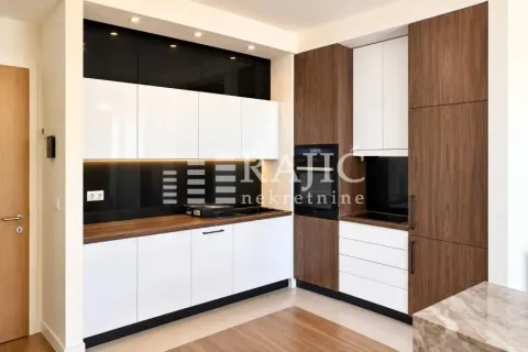 Modern kitchen with white and wood finish cabinets. - image 4