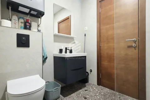 Small bathroom with a washbasin, mirror, and toilet. - image 9