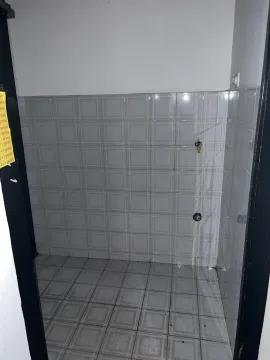 Empty tiled room with utility connections visible through a doorway. - image 5