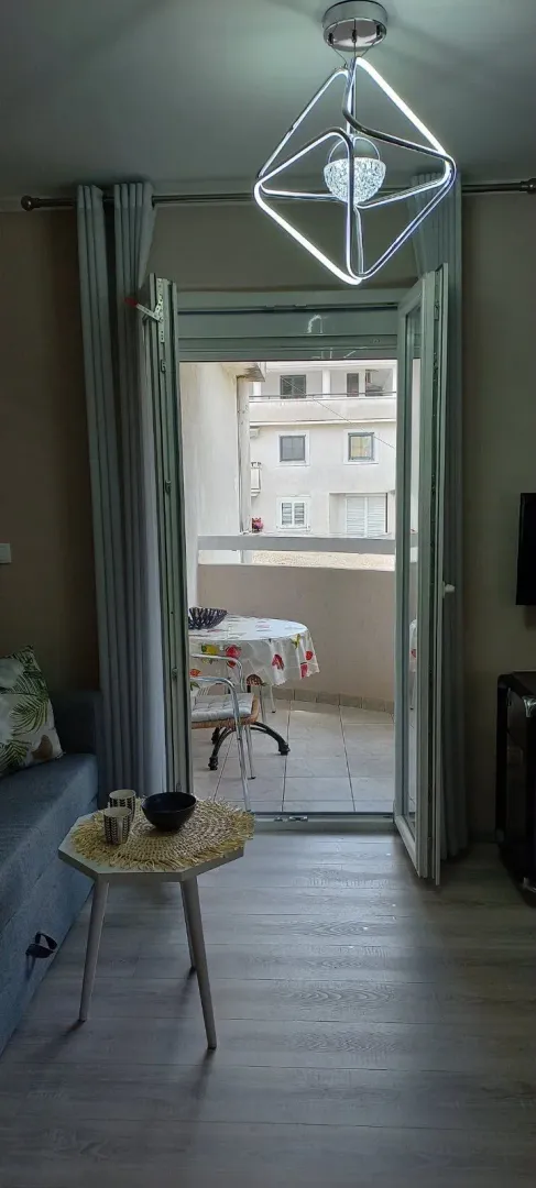 View from the living room towards the terrace with patio furniture.