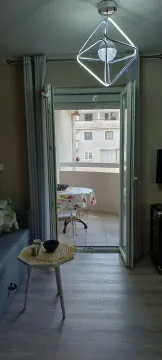 View from the living room towards the terrace with patio furniture. - image 8