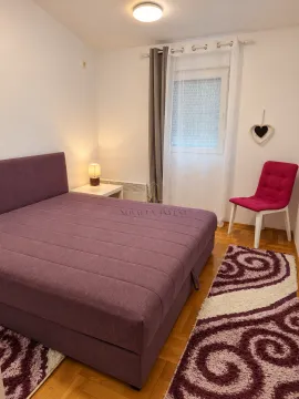 Bedroom with a double bed, nightstand, and armchair. - image 6