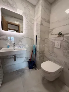 Moderne kupatilo obloženo keramičkim pločicama sa umivaonikom i toaletom. - image 10