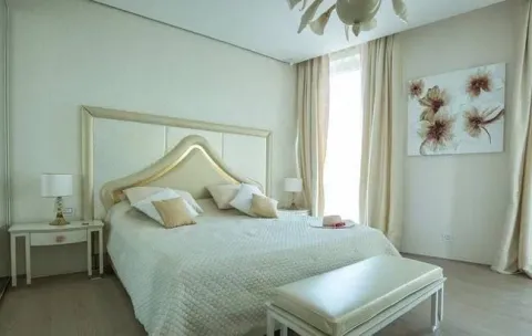 Spacious bedroom with a large double bed and light interior tones. - image 5