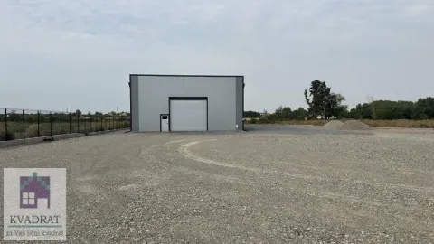 Exterior view of an industrial building with a large gravel-paved yard. - image 2