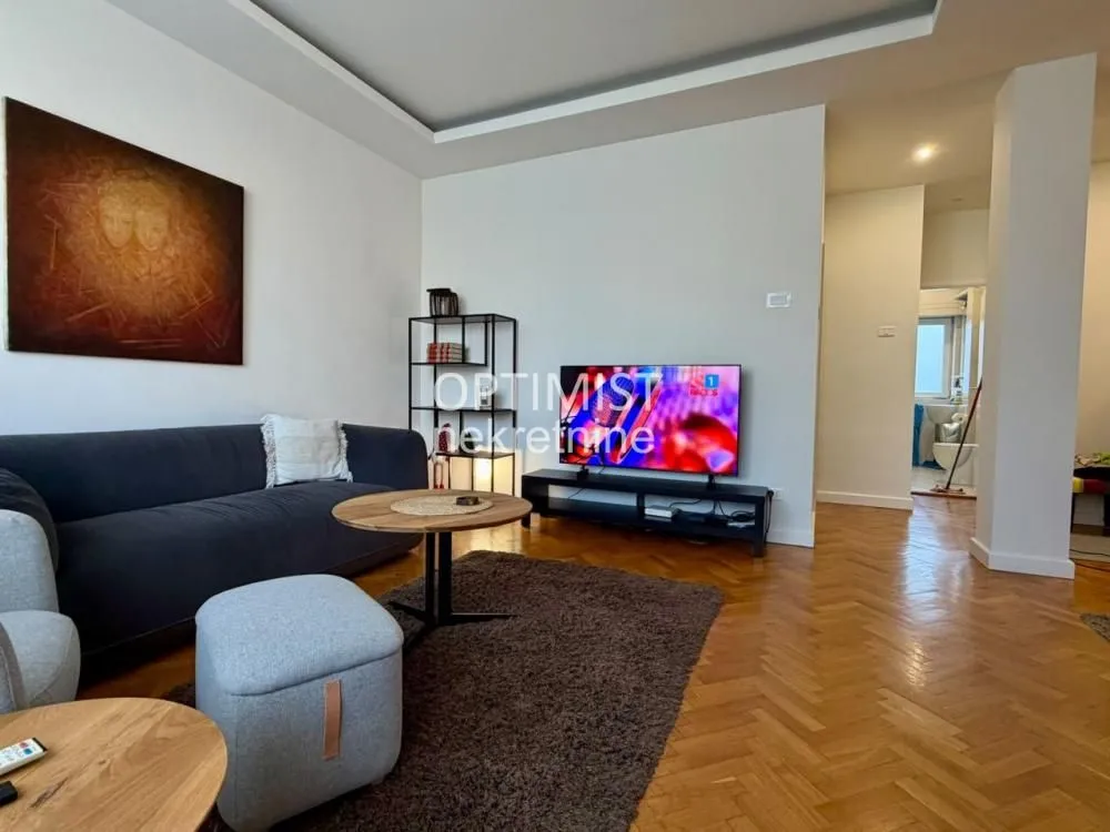 Living room with sofa, coffee table and television.