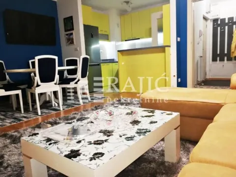 Living room with dining area and a view of the kitchen. - image 2