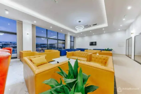 Spacious living room with yellow armchairs and large glass surfaces. - image 11