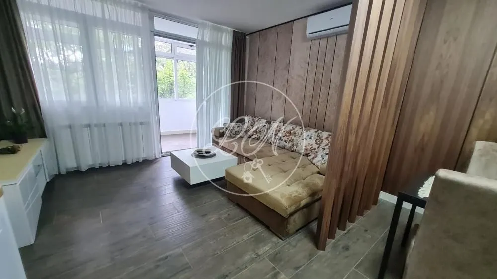 Living room with sofa, coffee table, and access to the terrace.