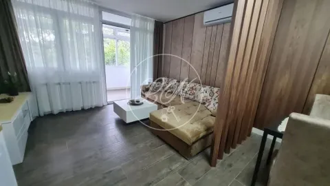 Living room with sofa, coffee table, and access to the terrace. - image 4