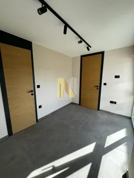 Empty room with two doors and ceramic tile flooring. - image 9