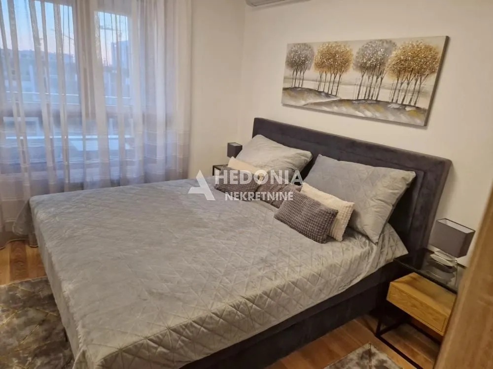 Bedroom with a double bed, nightstands, and a window with curtains.