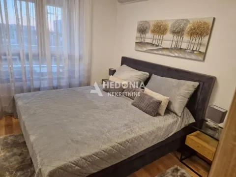 Bedroom with a double bed, nightstands, and a window with curtains. - image 10