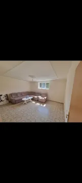 Bright living room with a corner sofa and tiled floor. - image 19