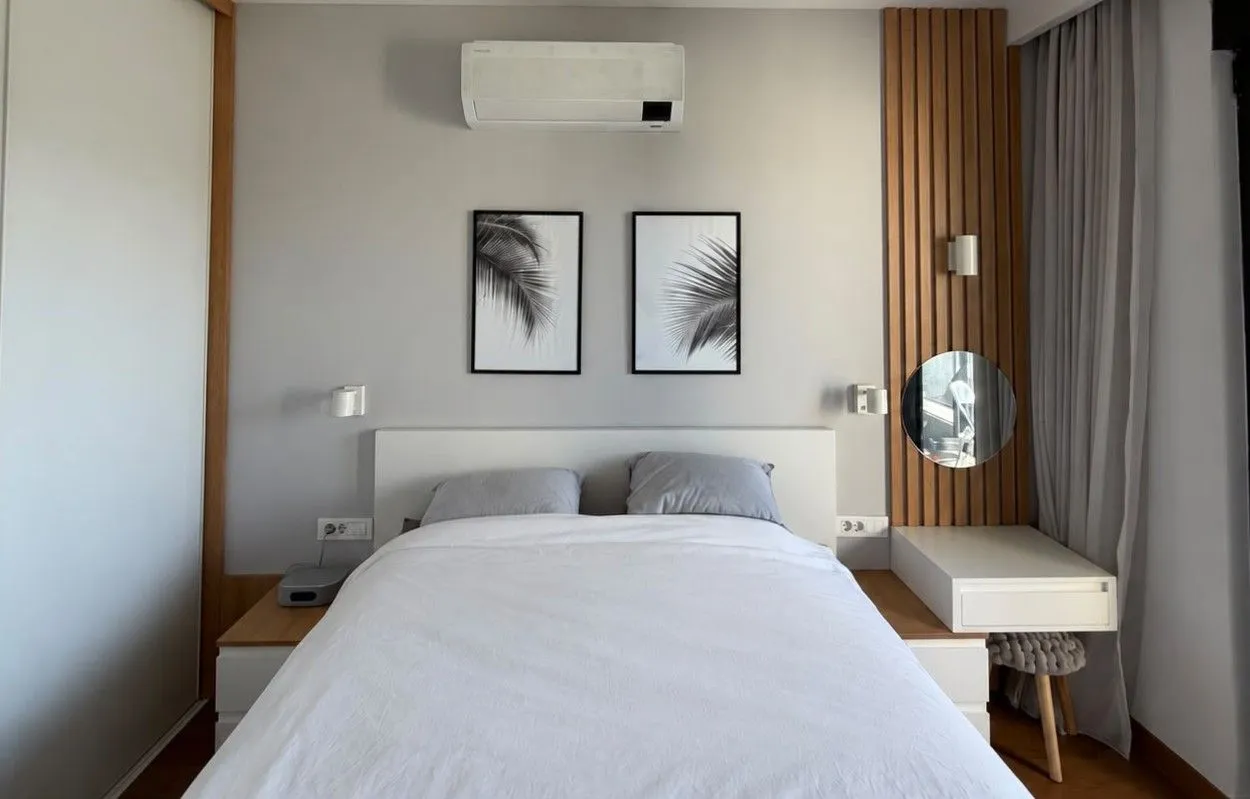 Modern bedroom with a double bed and built-in wardrobe.