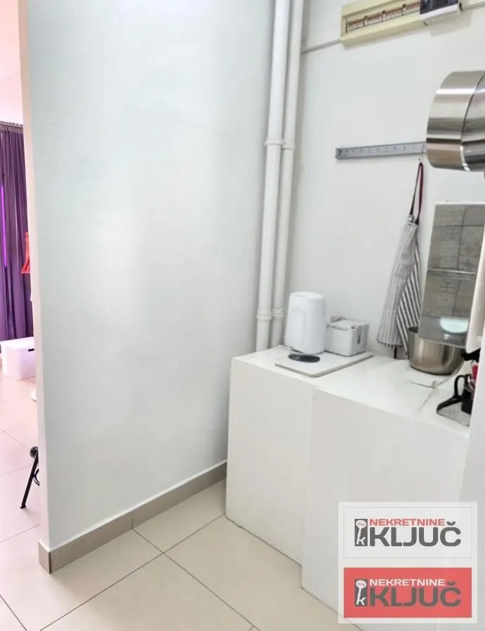 Small kitchen with white units and appliances.