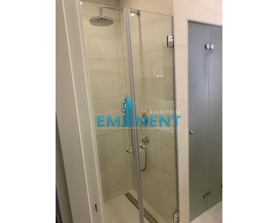 View of the shower cabin with a glass screen in the bathroom.