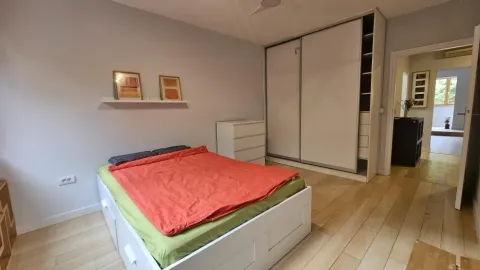 Bedroom with a double bed, large wardrobe and wooden flooring. - image 11