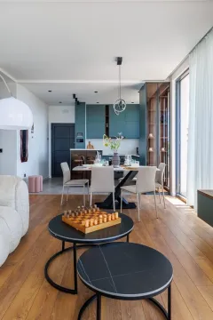 Modern living room with a dining area and kitchen in the background. - image 7