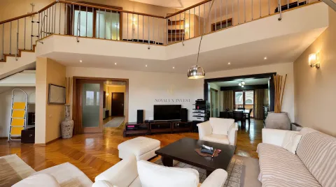 Spacious living room with a gallery and parquet flooring. - image 3