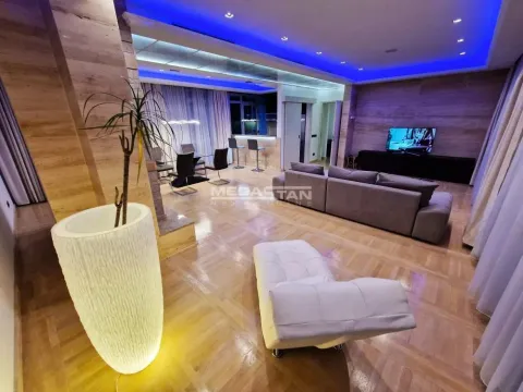 Spacious living room with a sofa set, dining area, and parquet flooring. - image 2
