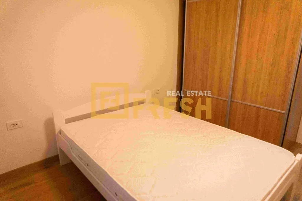 Furnished bedroom with a double bed and built-in wardrobe.