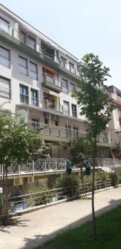 Exterior of a residential building with balconies and trees. - image 2