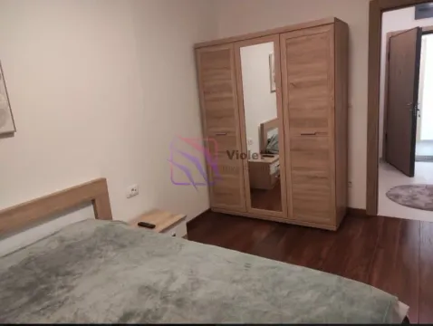 Furnished bedroom with a double bed and a wooden wardrobe. - image 6
