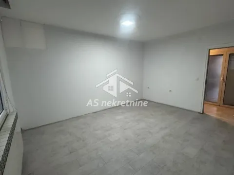 Empty room with white walls and grey flooring. - image 5