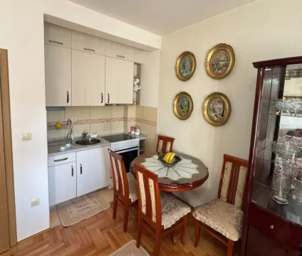 A small kitchen with a dining table and wooden chairs. - image 3