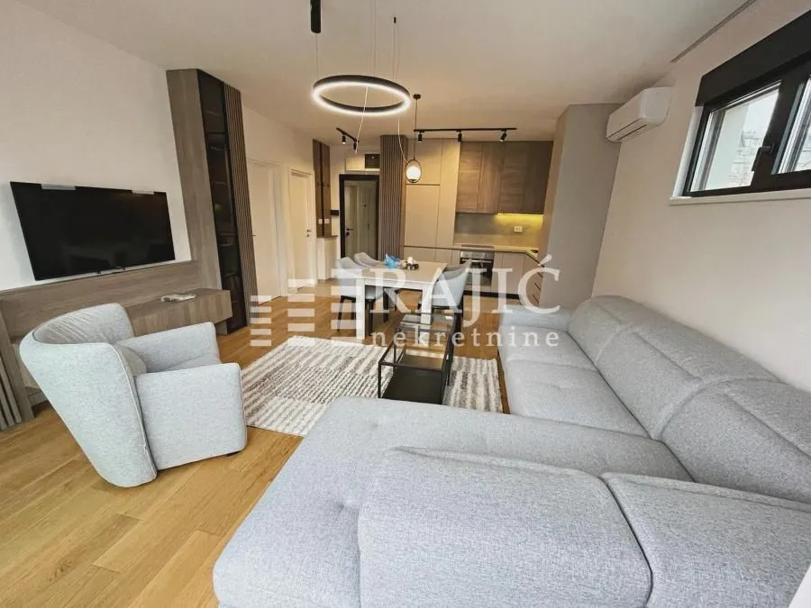 Modern living room connected to the dining area and kitchen.