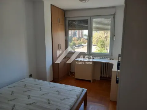 Furnished bedroom with a bed, fitted wardrobe, and a window overlooking the neighborhood. - image 6