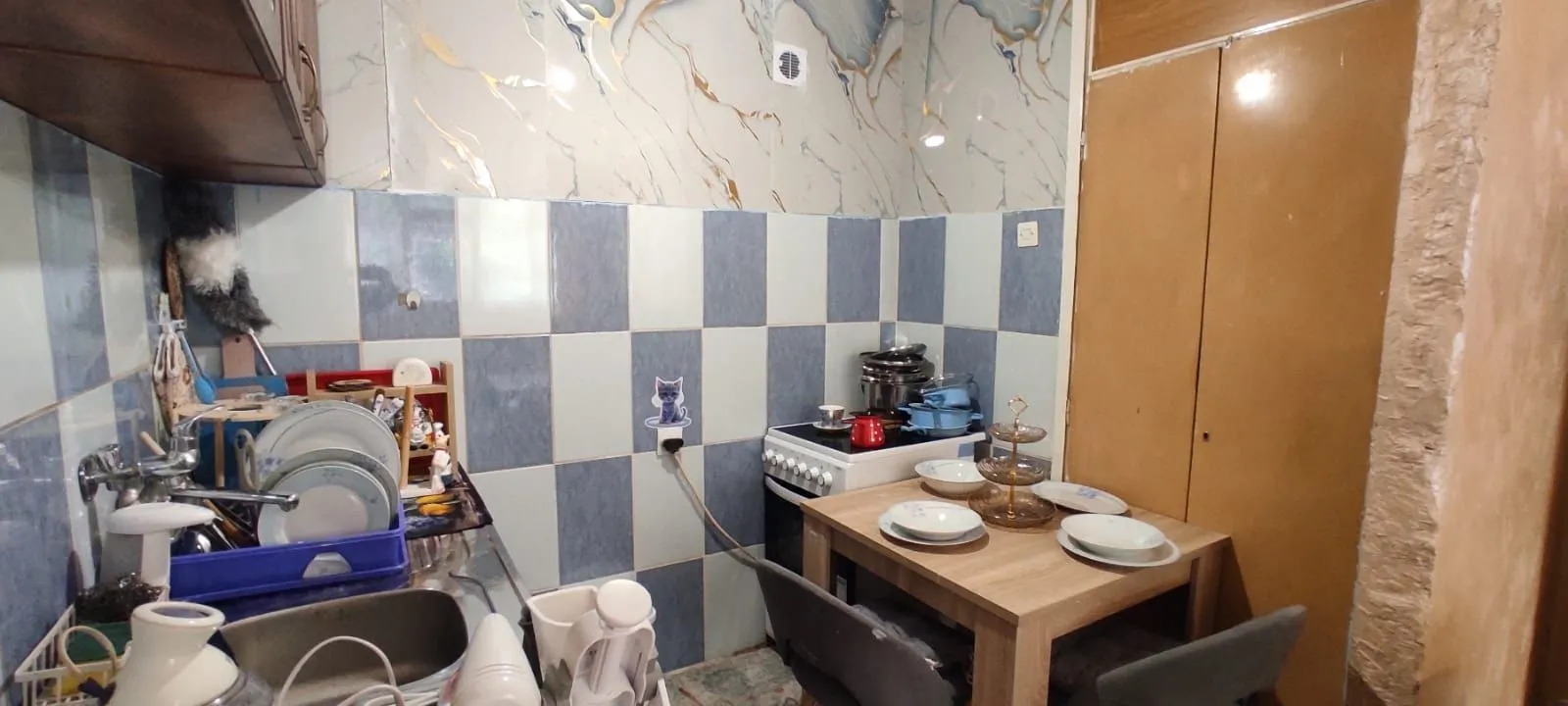 Small kitchen with a dining table and a sink.