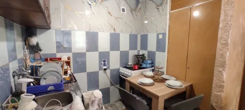 Small kitchen with a dining table and a sink. - image 5