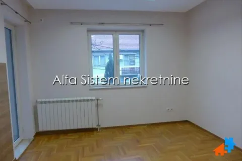 Empty room with a window, wooden parquet flooring, and a radiator. - image 11