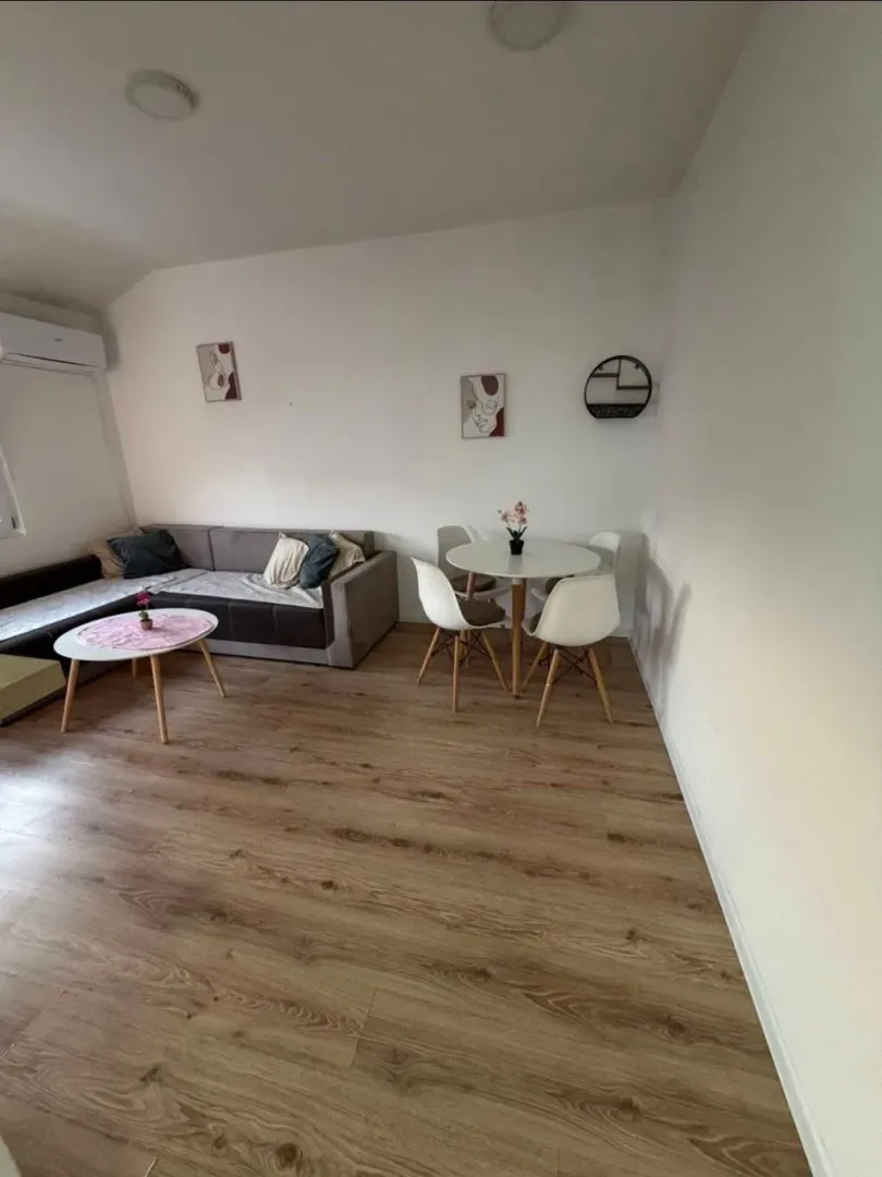 Living room with a sofa and dining table.