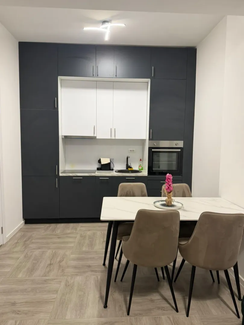 Modern kitchen with a dining table and chairs.