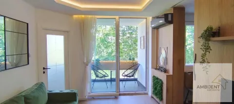 Living room with access to the terrace and green furniture. - image 16