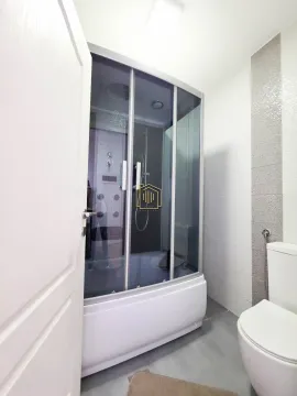 Bathroom with a shower cabin and toilet. - image 15