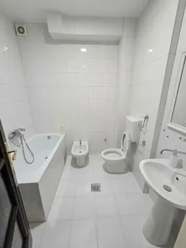 Bright equipped bathroom with a bathtub, washbasin, and sanitary fixtures. - image 10