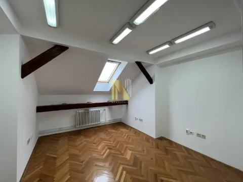 Attic room with parquet flooring, white walls, skylight and wooden beams. - image 4
