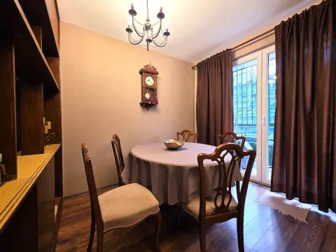 Dining room with a wooden table, chairs, and a chandelier. - image 4
