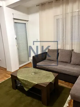 Living room with a sofa and a coffee table. - image 2