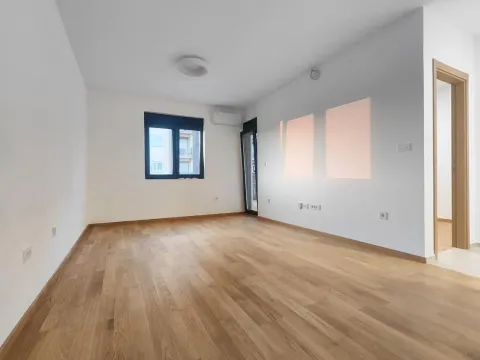 Empty bright room with parquet flooring, white walls, and a window. - image 6
