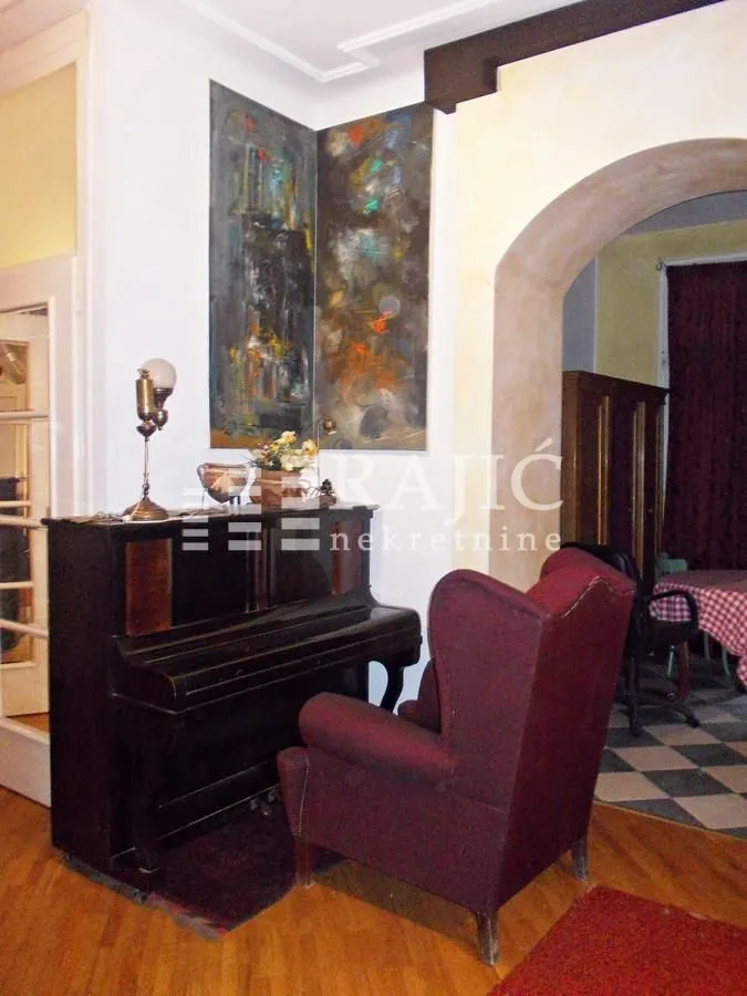 Living room with a piano and an armchair.