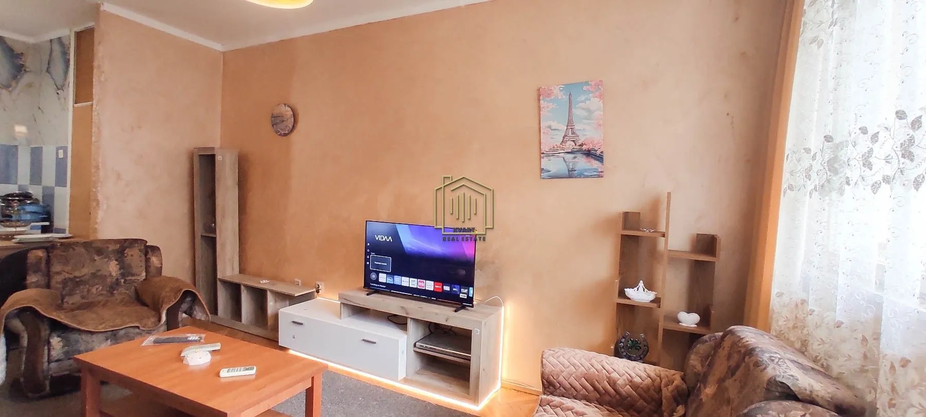 Furnished living room with a sofa set, television, and coffee table.